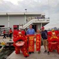 Charlie Russo (Simpson Gumpertz & Hegel), Deb and Barry Lipsett of Charles River Apparel , and lion dancers from Wah Lum Kung Fu & Tai Chi Academy