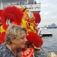 Deb Lipsett dotting the eye of our newest dragon boat, donated by Charles River Apparel